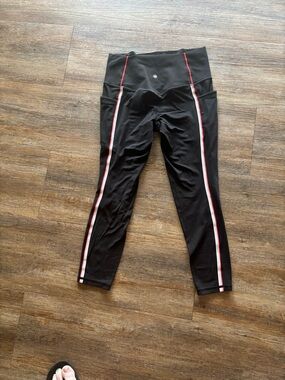 Athleta Salutation stash tipped tight. with Red and White Side Stripes